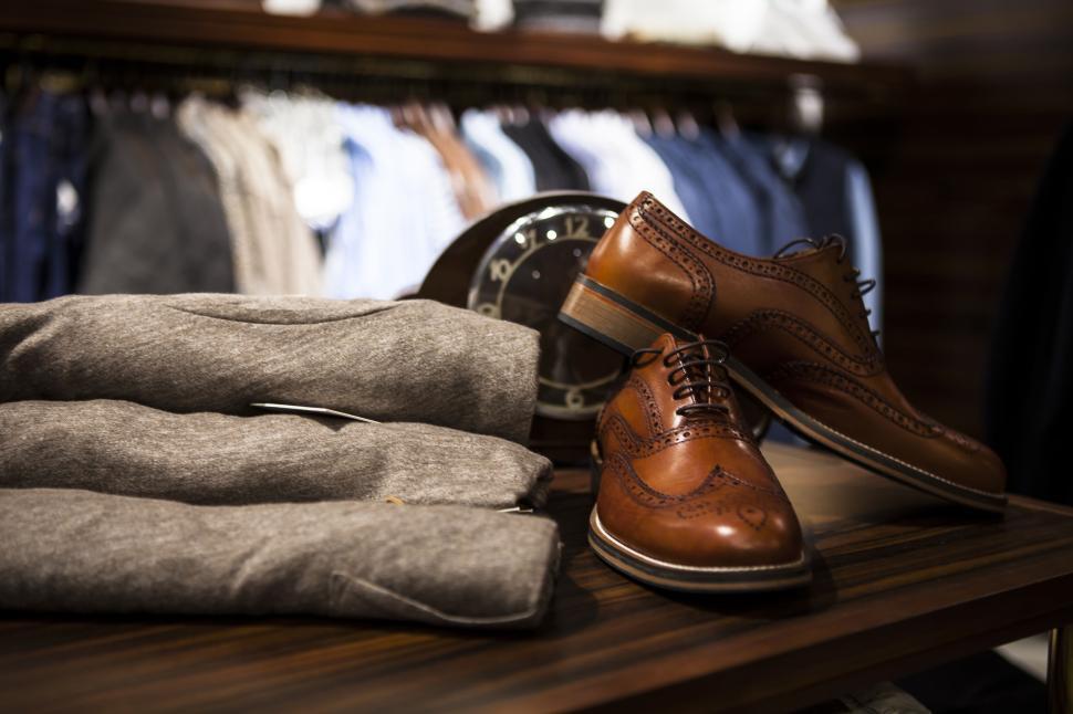 Free Image of Formal men s leather shoes and folded woolen suits. 