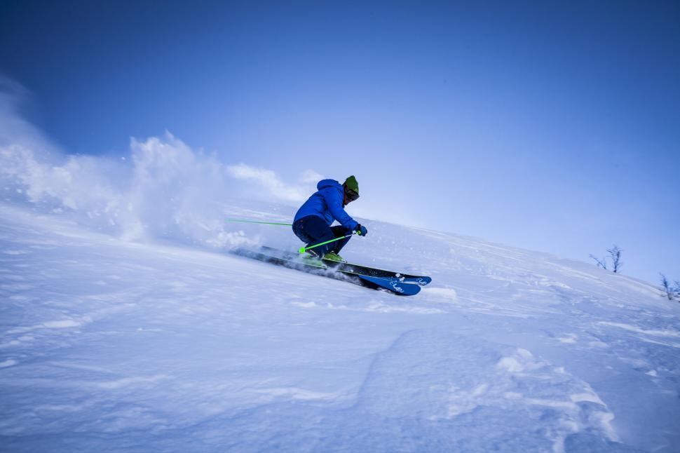 Free Image of Skier descending rapidly down a snowy slope. 