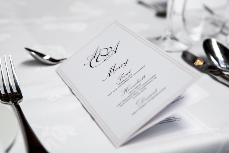 Free Image of Elegant table setting with a card on a white tablecloth. 