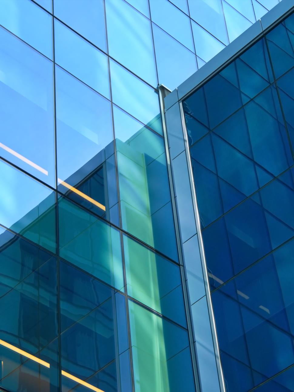 Free Image of Modern glass building with abstract reflections sky light 