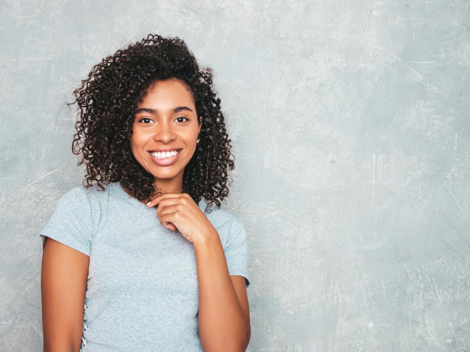 Free Image of Smiling young woman in grey top, casual indoor look 