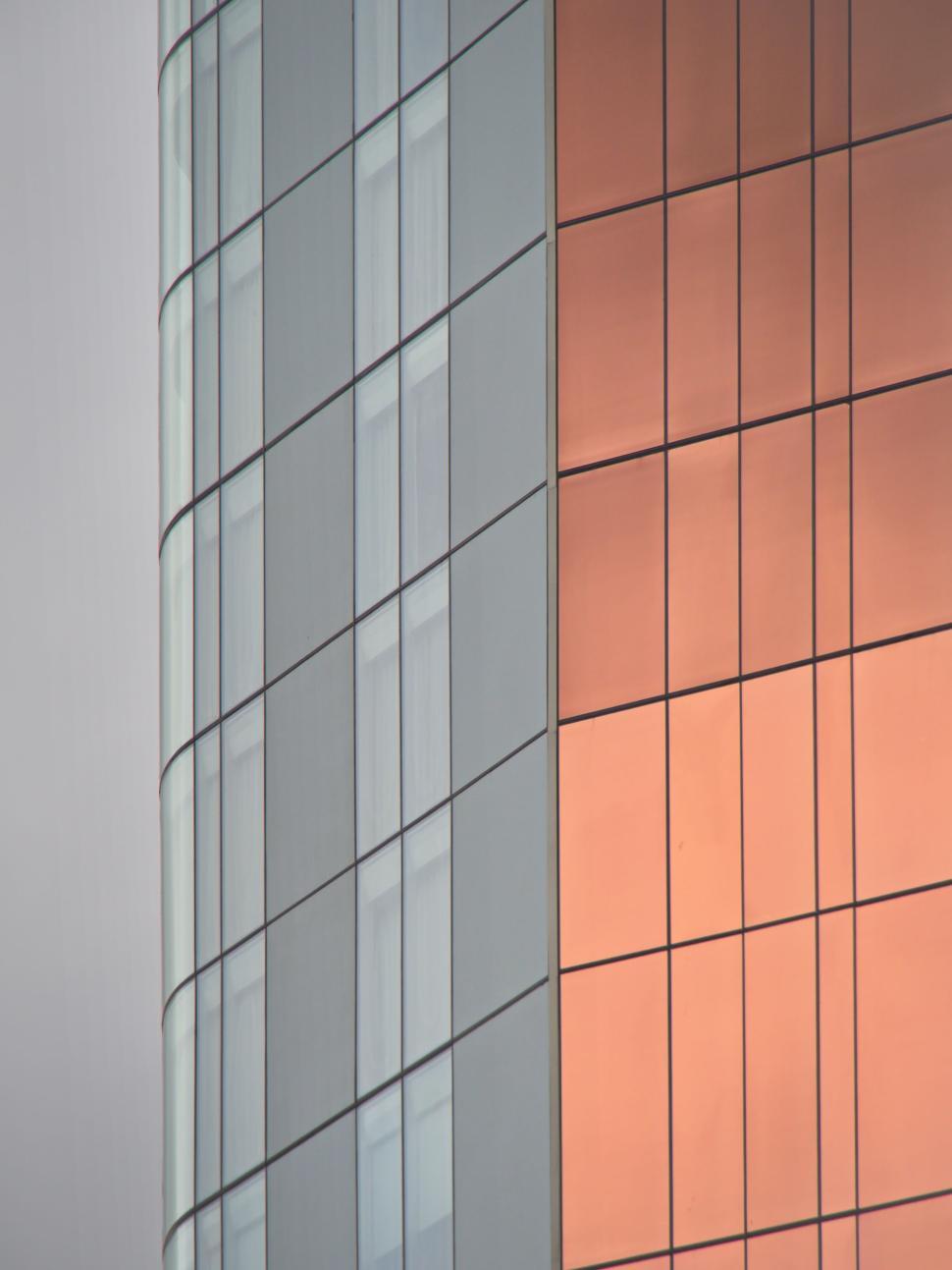 Free Image of Modern building with reflective glass façade at dusk 