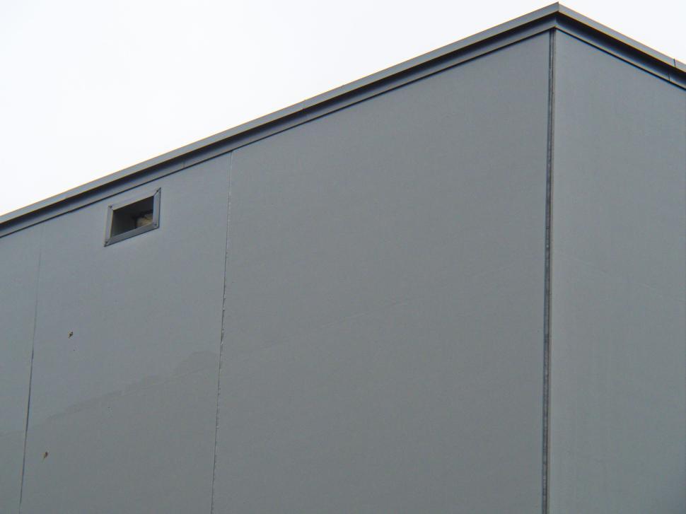 Free Image of Minimalist gray building with small window on top 