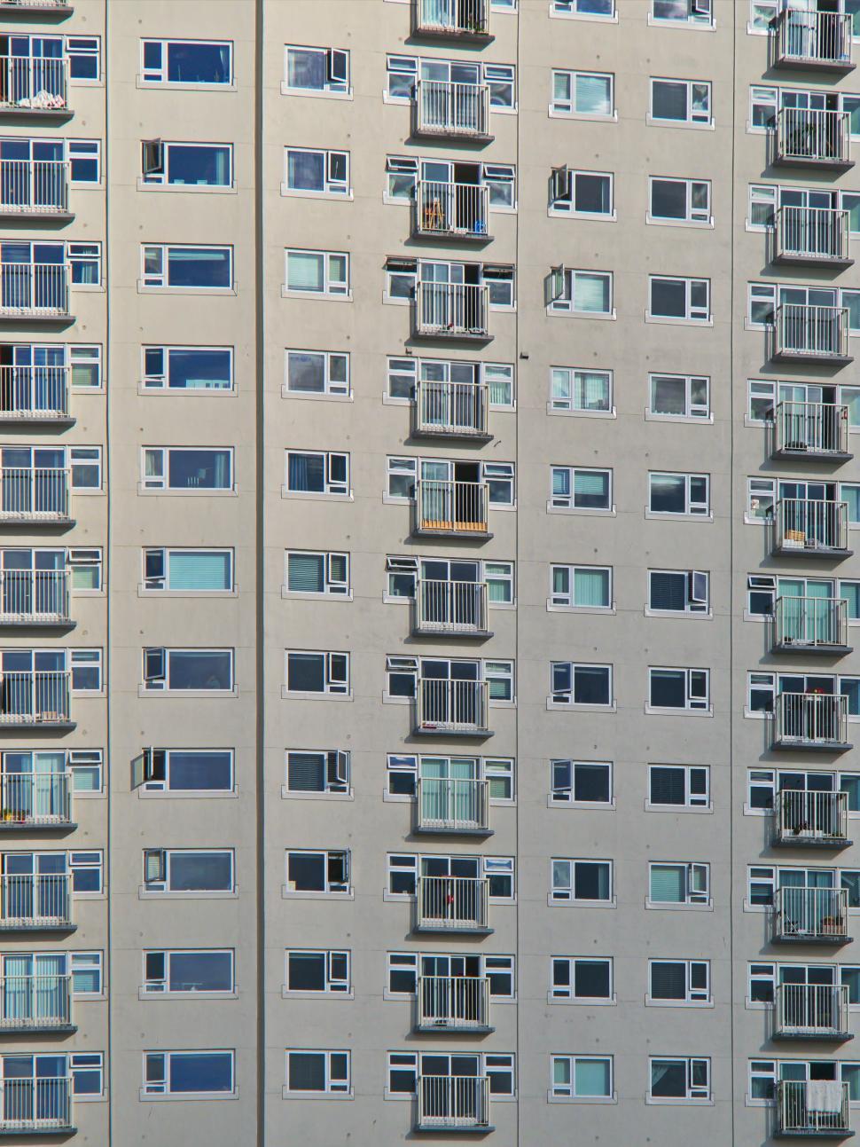 Free Image of High-rise apartment building with multiple balconies on façade 
