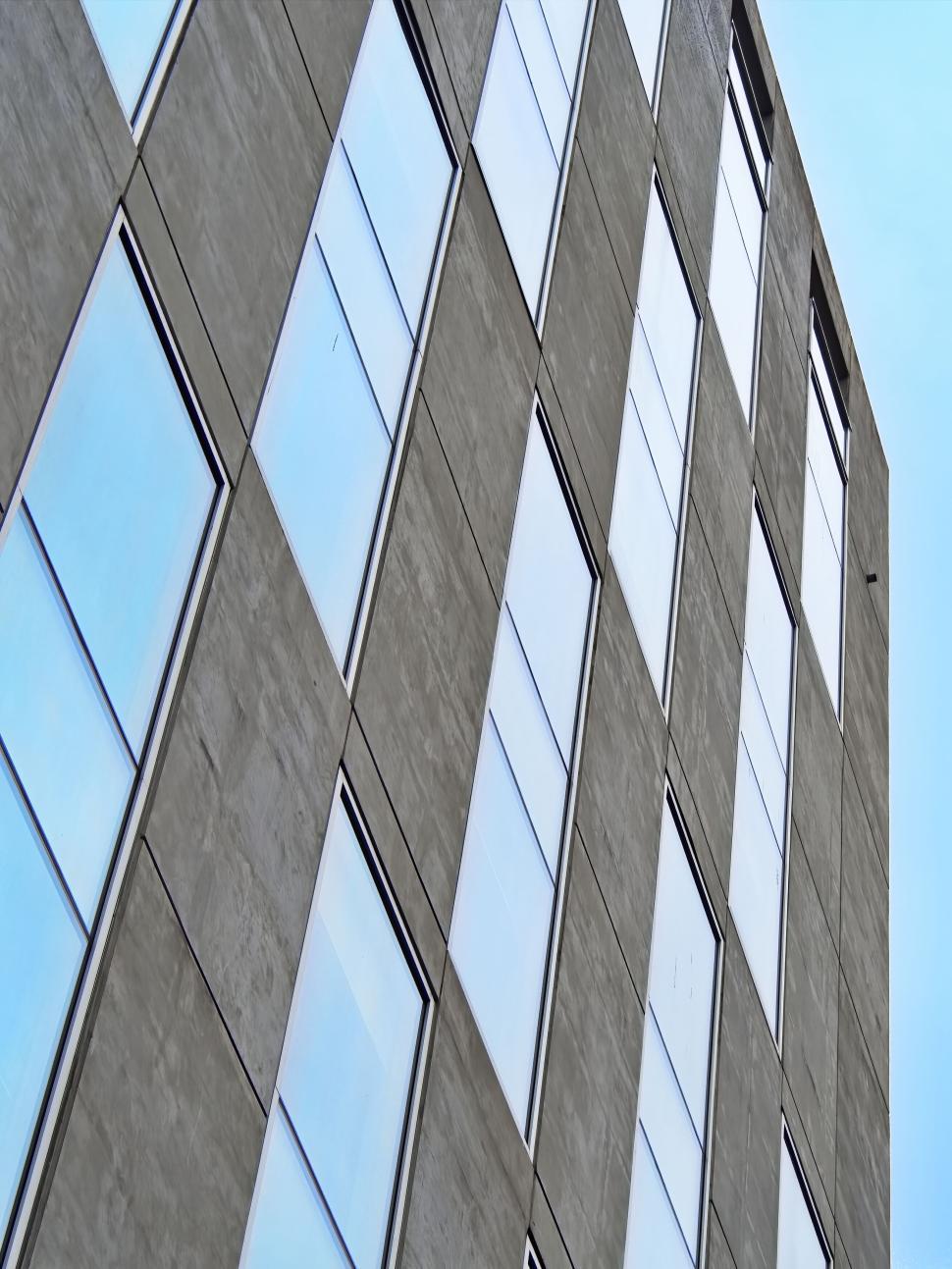 Free Image of Vertical grey building with checkerboard window pattern 