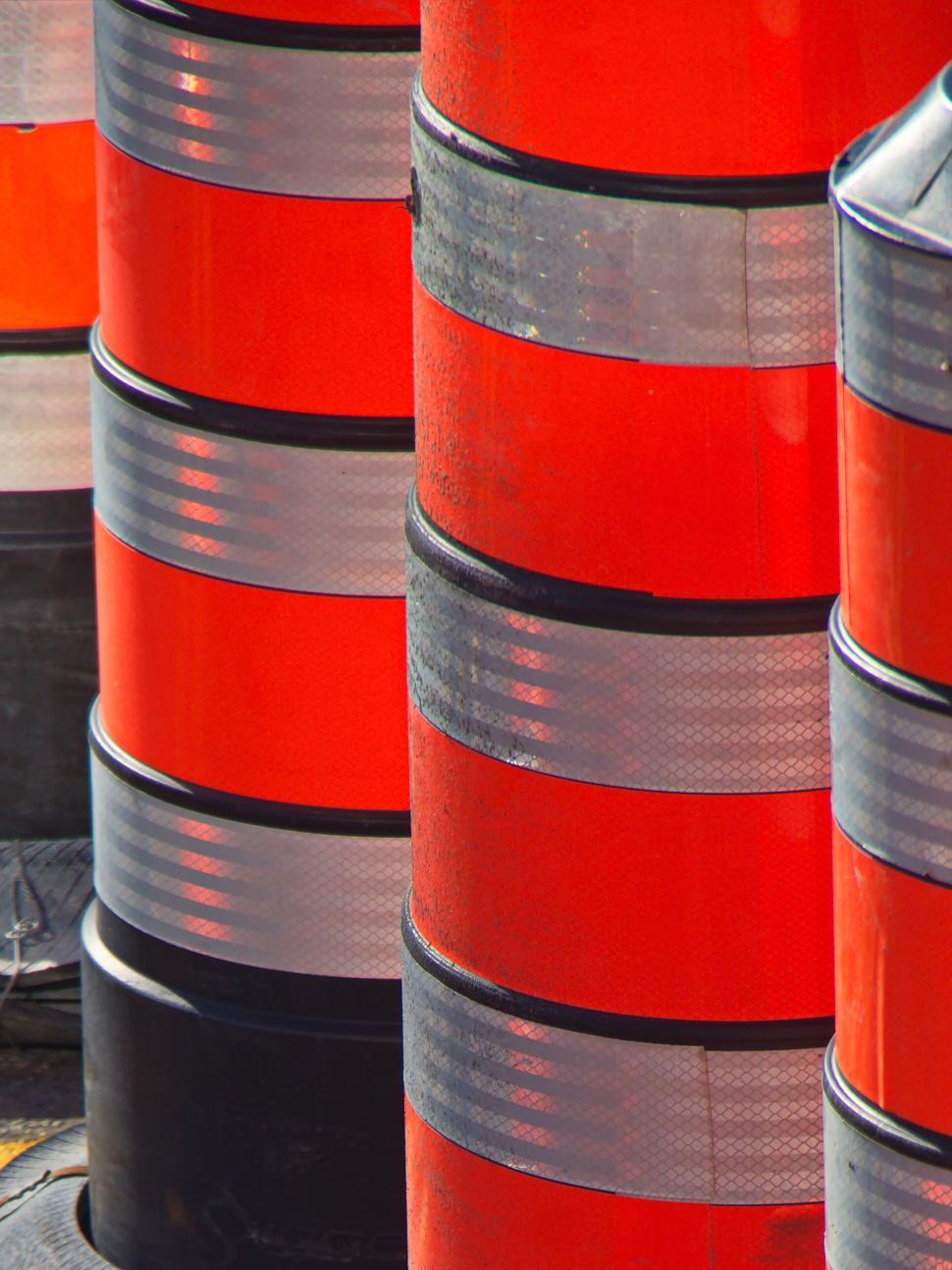 Free Image of Traffic safety barrels with reflective stripes close-up 