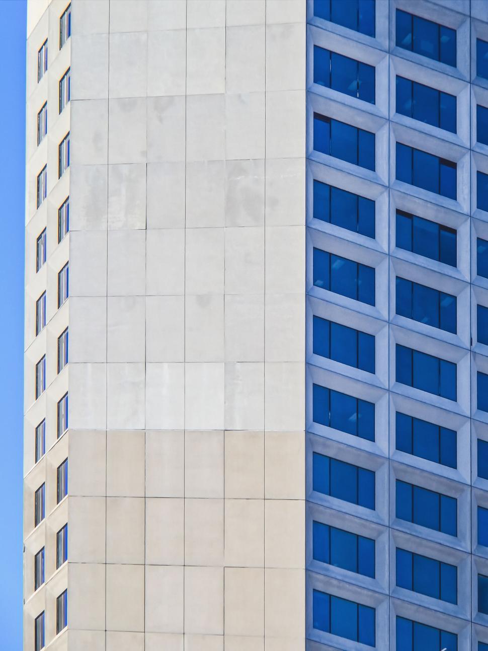 Free Image of High-rise building with diverse window designs under sky 