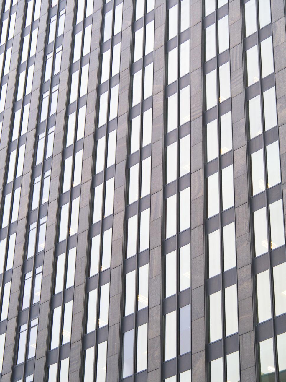 Free Image of Tall building with numerous identical rectangular windows 