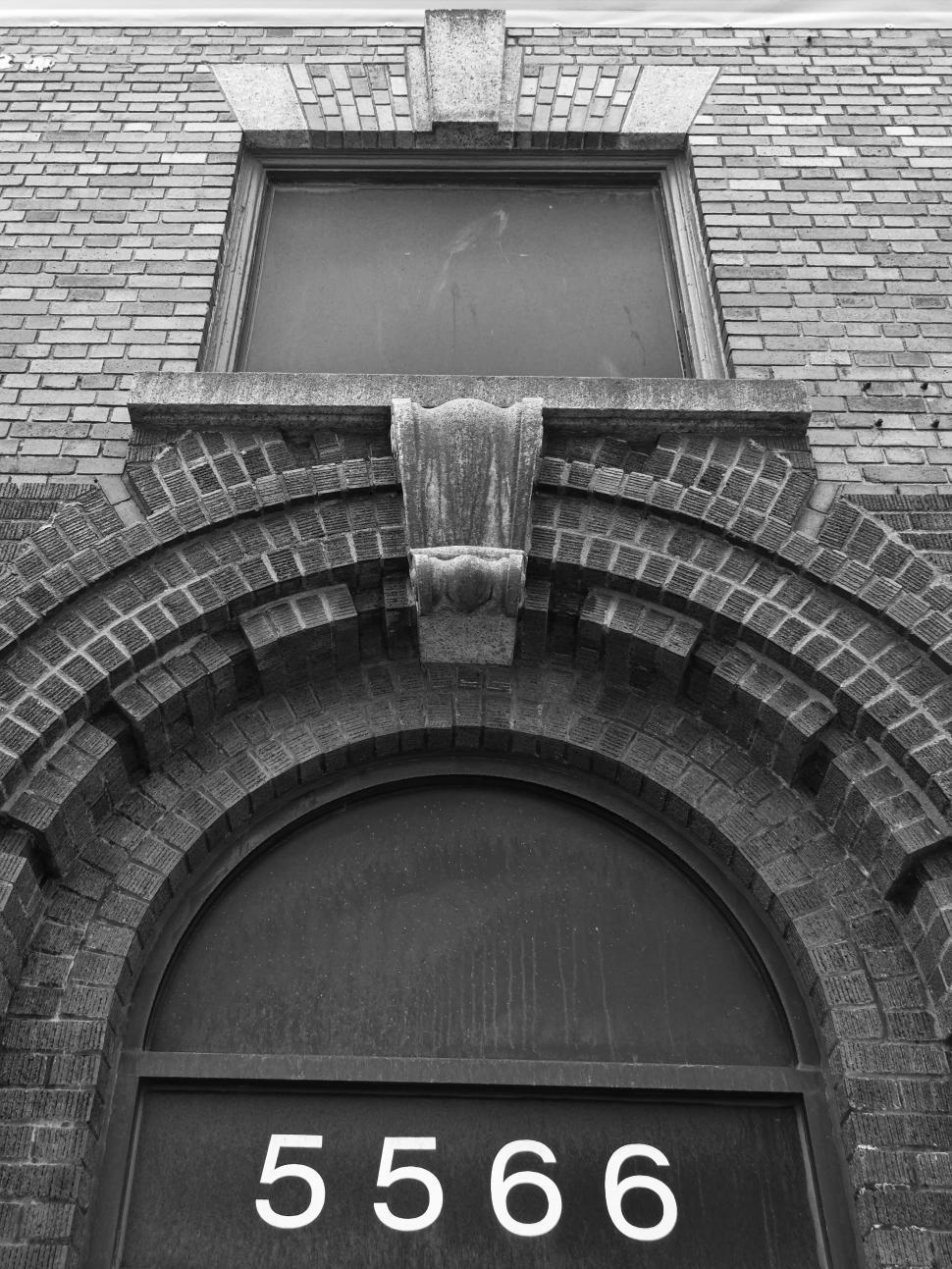 Free Image of Vintage brick building with arched windows and details 