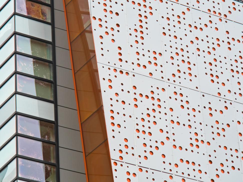 Free Image of Perforated Panel On Modern Building With Orange Accents 