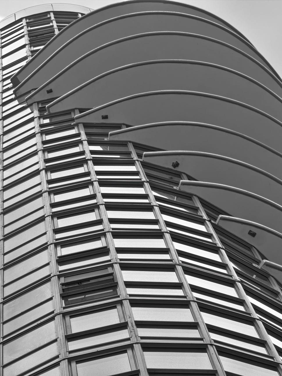 Free Image of Modern curved skyscraper with multiple segmented arcs 