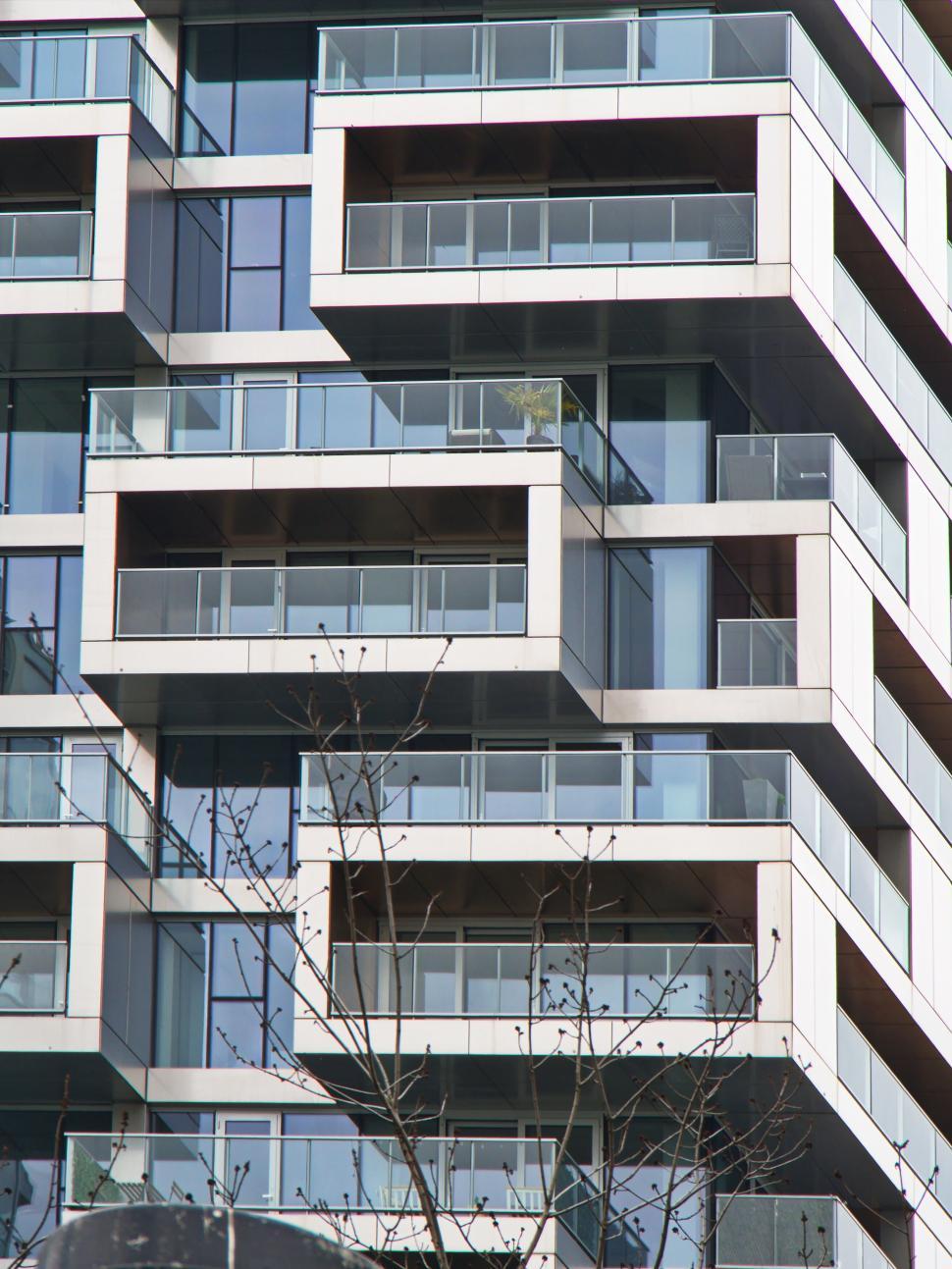 Free Image of Stacked glass balconies on a high-rise building view. 