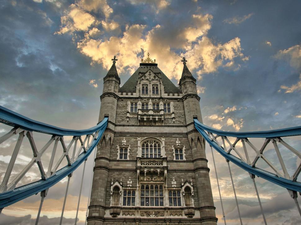 Free Image of Historic bridge tower at sunset with dynamic clouds. 