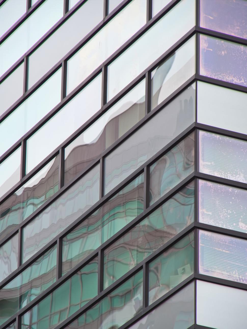 Free Image of Window reflections on glass facade of modern building. 