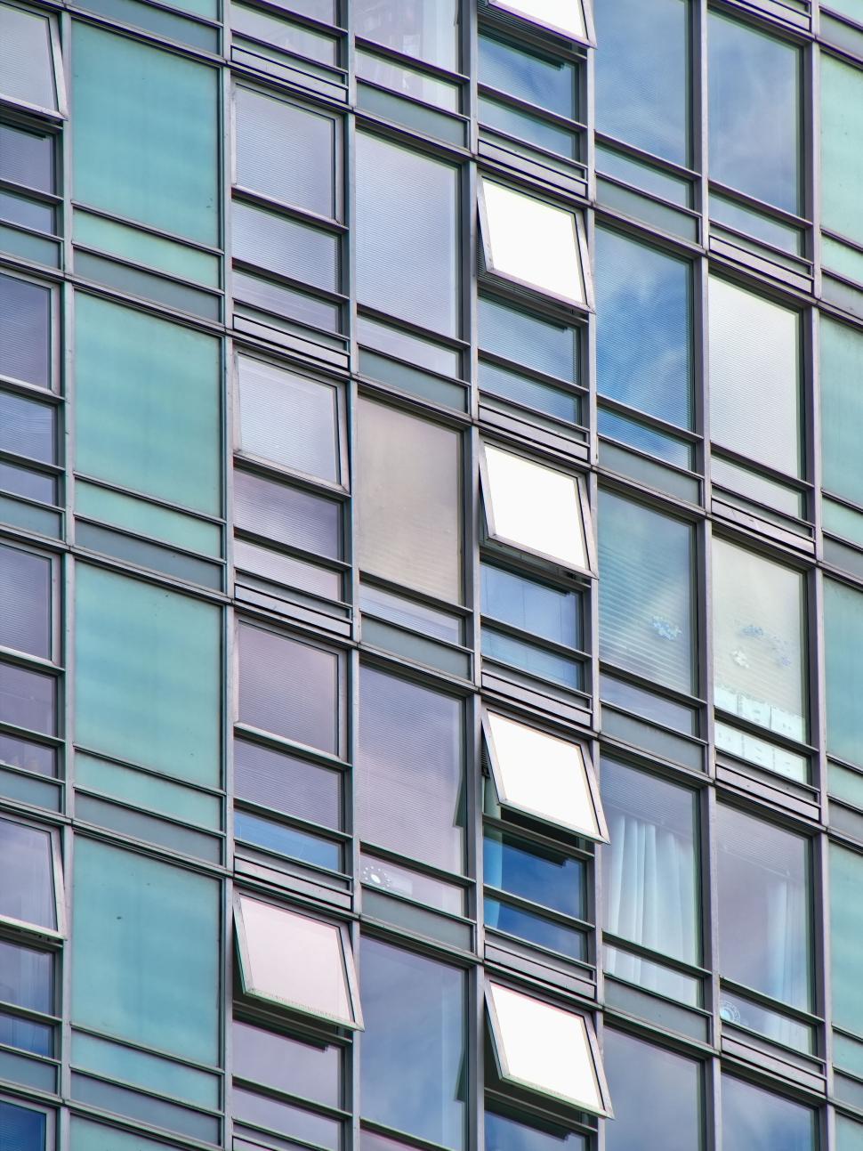 Free Image of Close-up of glass building with open and closed windows. 