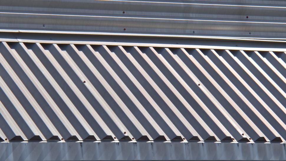 Free Image of Close-up of corrugated metal surface with linear designs. 