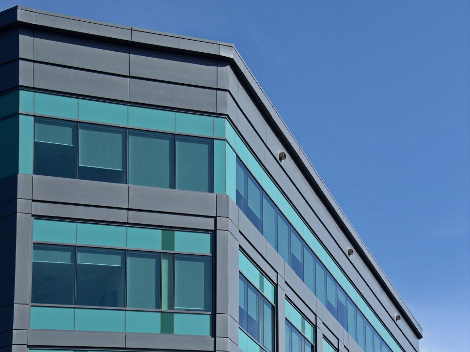 Free Image of Gray and green building with modern office windows 
