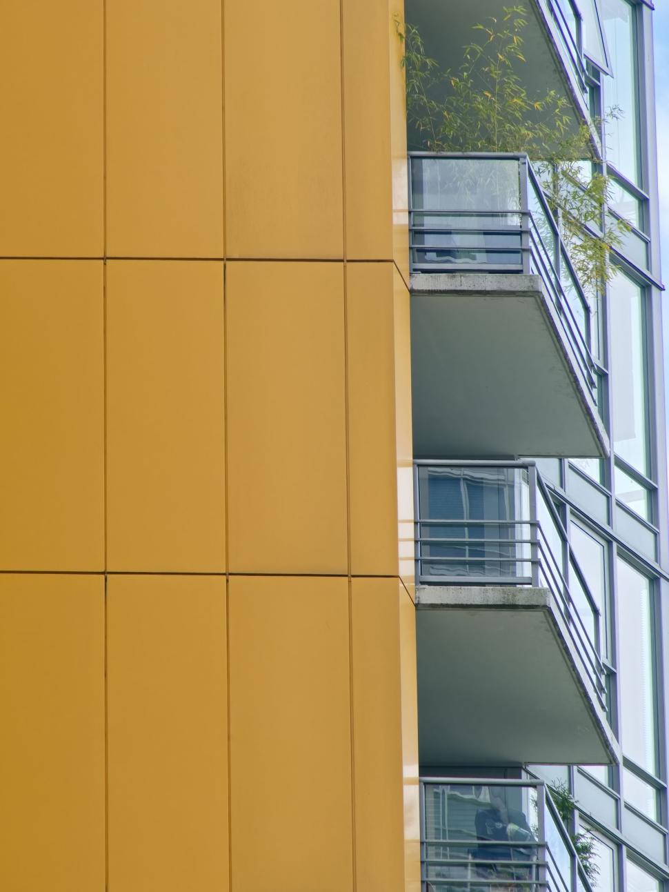 Free Image of Yellow modern residential building with balconies view 