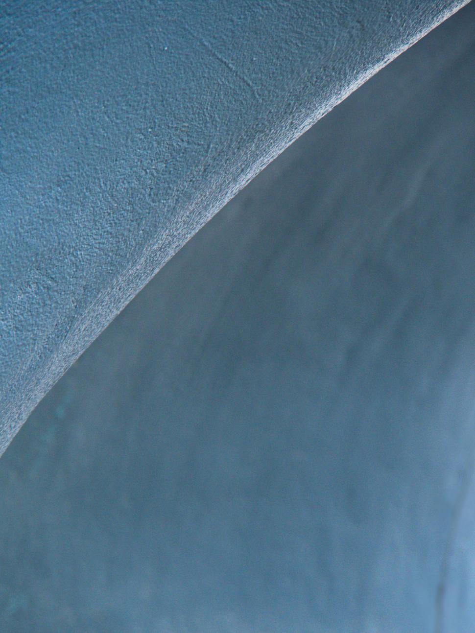 Free Image of Close-up of textured blue concrete surface in shadow 
