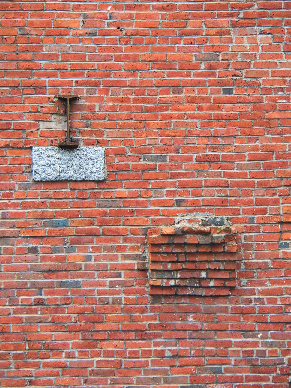 Free Image of Red brick wall with visible and missing bricks pattern. 