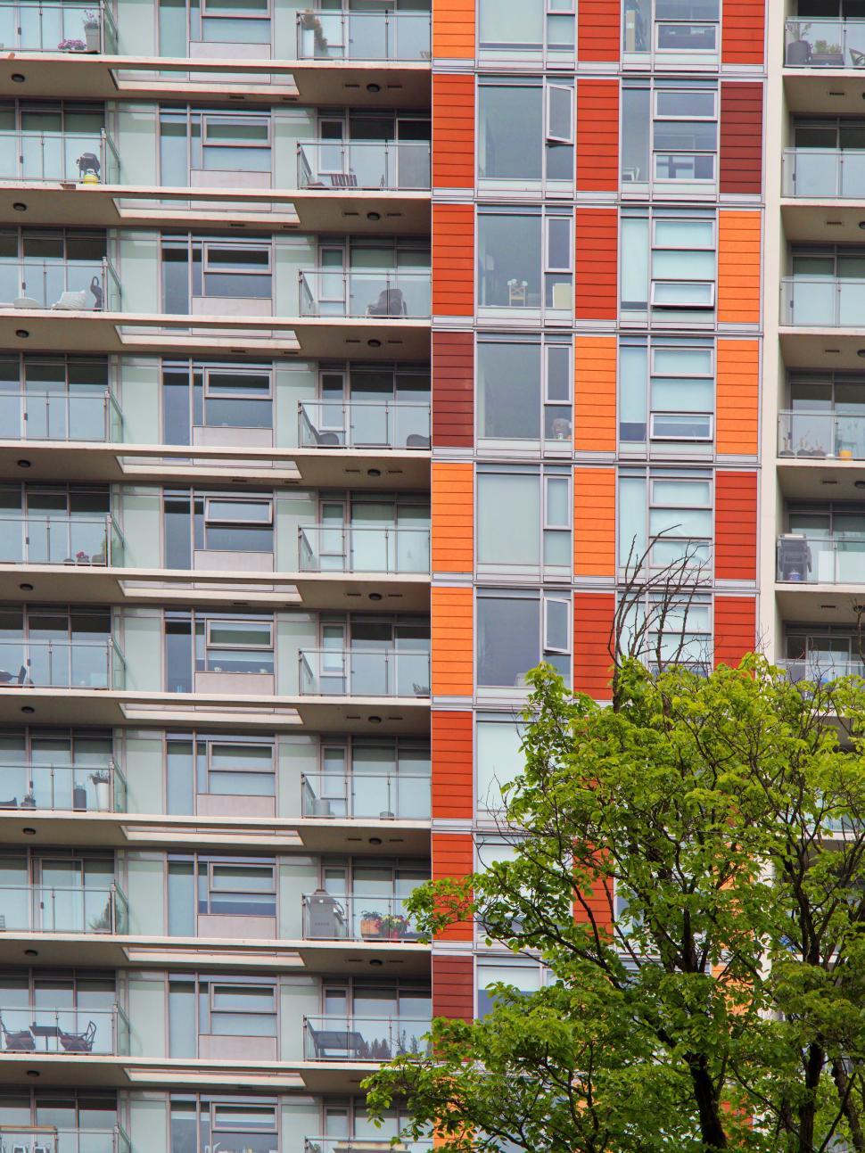 Free Image of High-rise building with colorful facade and balconies. 