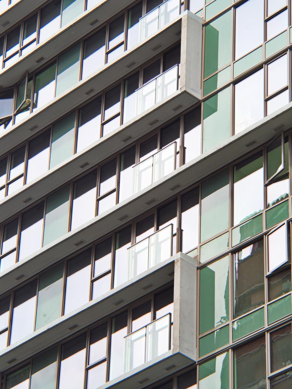 Free Image of Glass building facade with linear balconies and windows. 