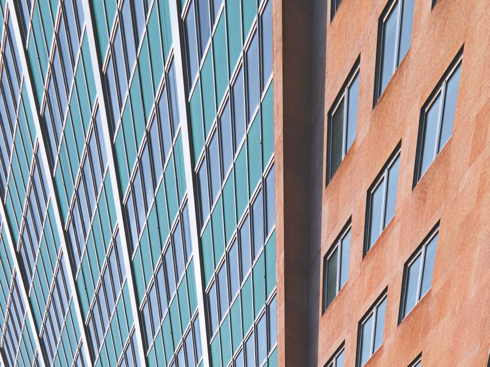 Free Image of Close-up of the geometric patterns of two skyscrapers shown. 