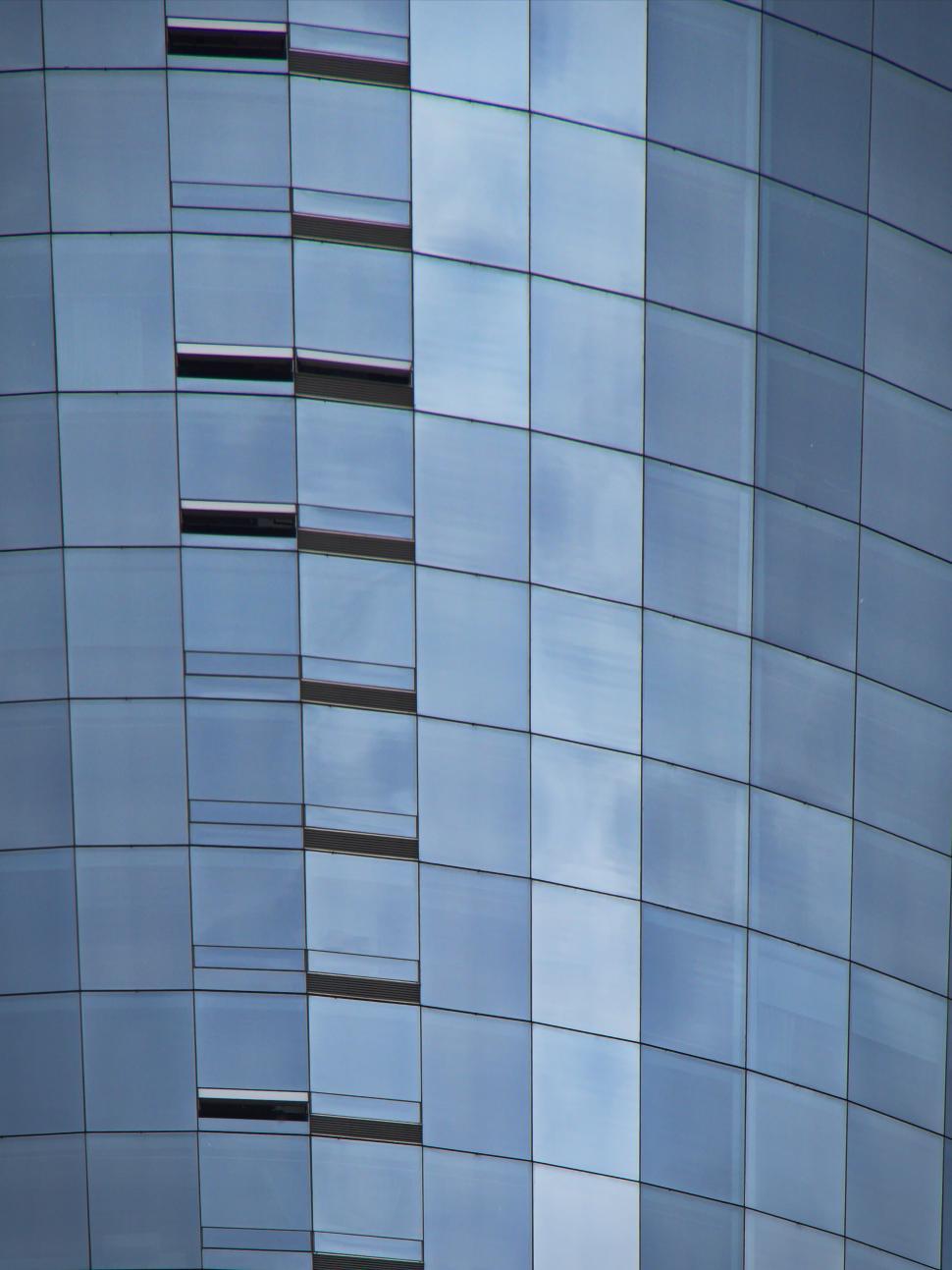 Free Image of Curved modern skyscraper with glass panel exterior 