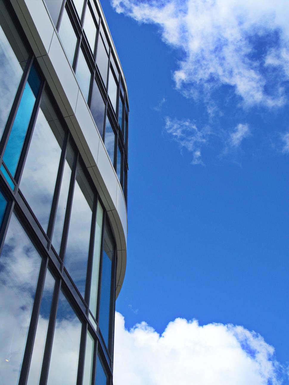 Free Image of Modern building with reflective glass under blue sky 