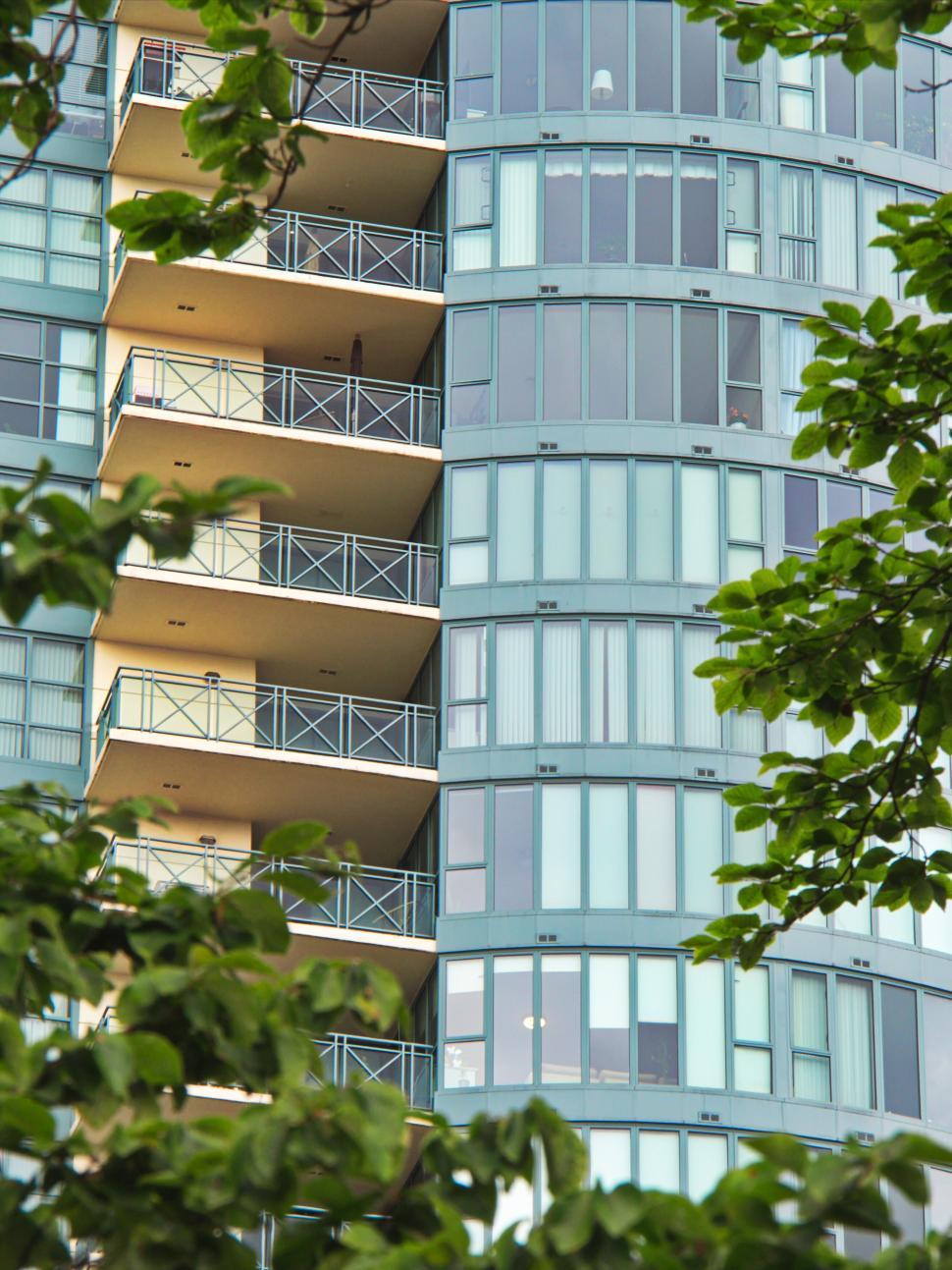 Free Image of Residential glass building with balconies and greenery 