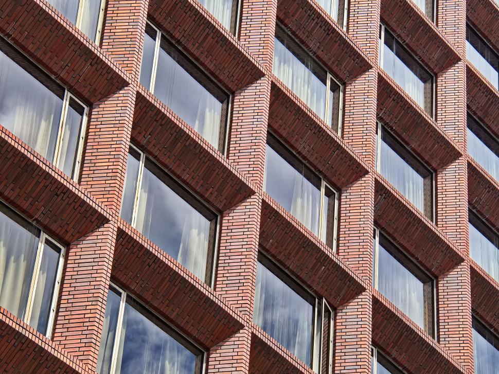 Free Image of Brick building with indent windows in repetitive pattern. 