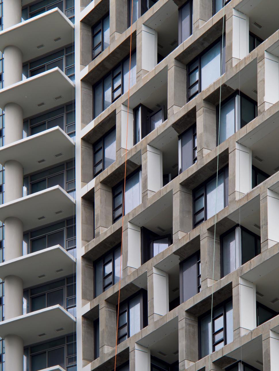 Free Image of High-rise building with geometric balconies and windows 