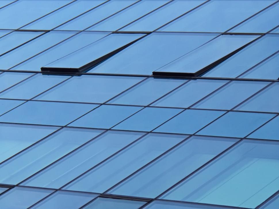 Free Image of Modern blue tinted glass windows grid pattern facade. 