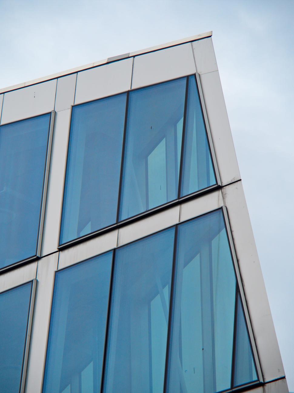Free Image of Sharp Angled Modern Glass Building Against Sky 