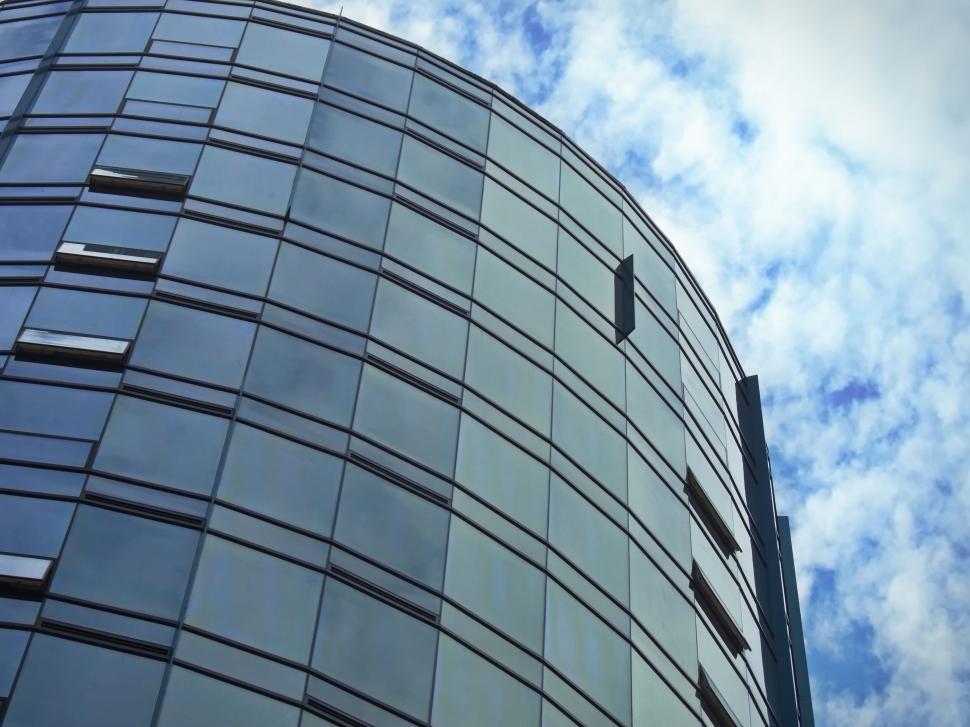 Free Image of Modern glass office building against blue sky image 