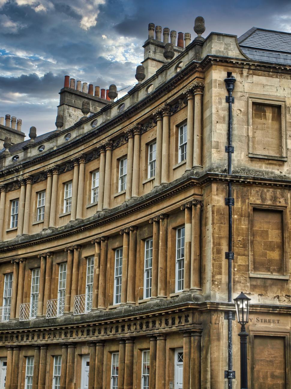 Free Image of Historic building with columns under dramatic cloudy sky 