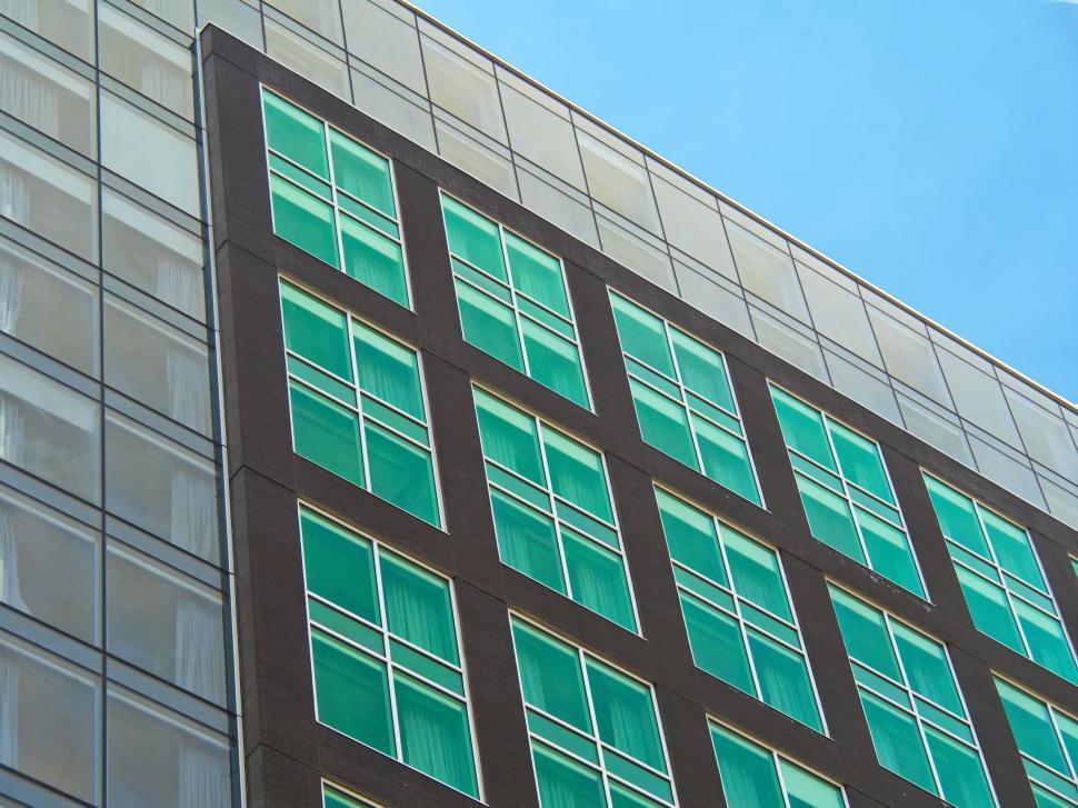 Free Image of Modern facade with green windows and minimalist lines 