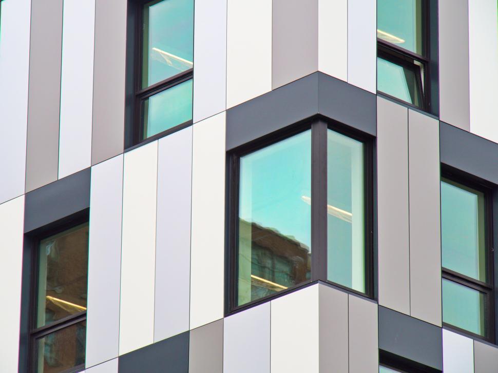 Free Image of Modern building facade with reflective windows close-up 