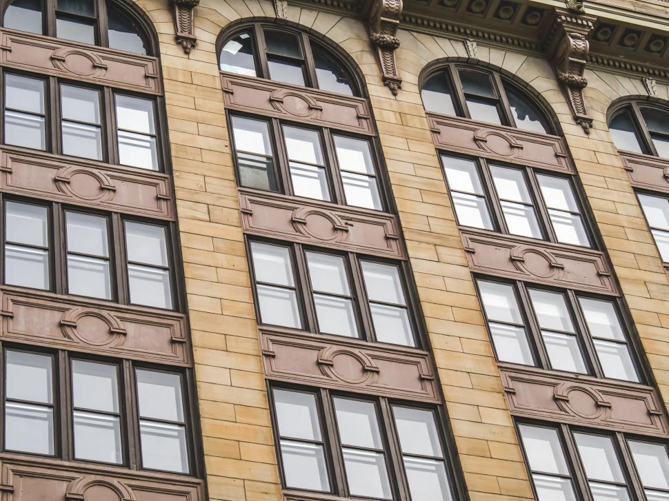 Free Image of Historic building facade with numerous windows and arches 
