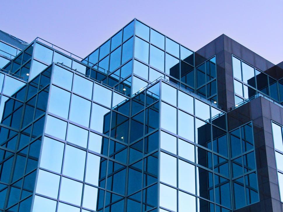 Free Image of Modern glass building complex reflecting the twilight sky 