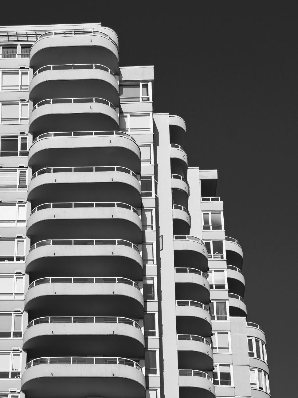 Free Image of Curved balconies on a modern high-rise building exterior. 