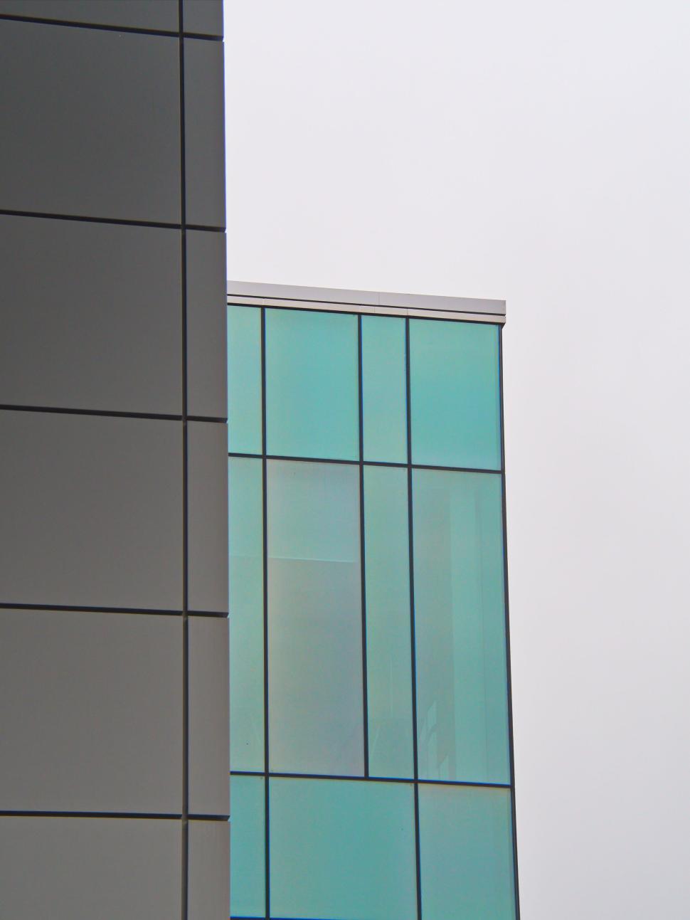 Free Image of Colorful glass-windowed building section with metal paneling. 