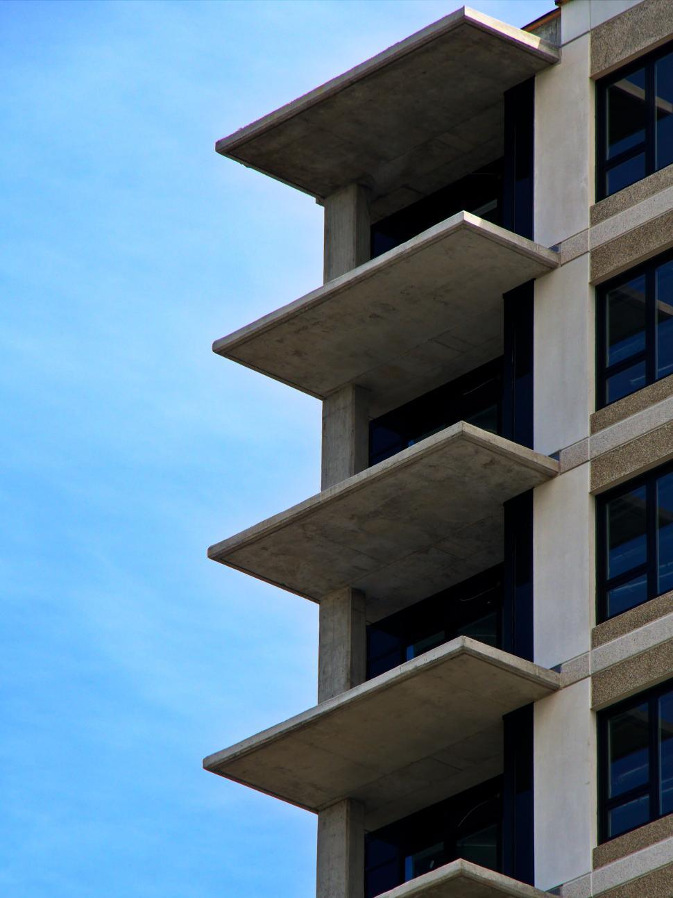 Free Image of Concrete balconies on a high-rise building s side view. 