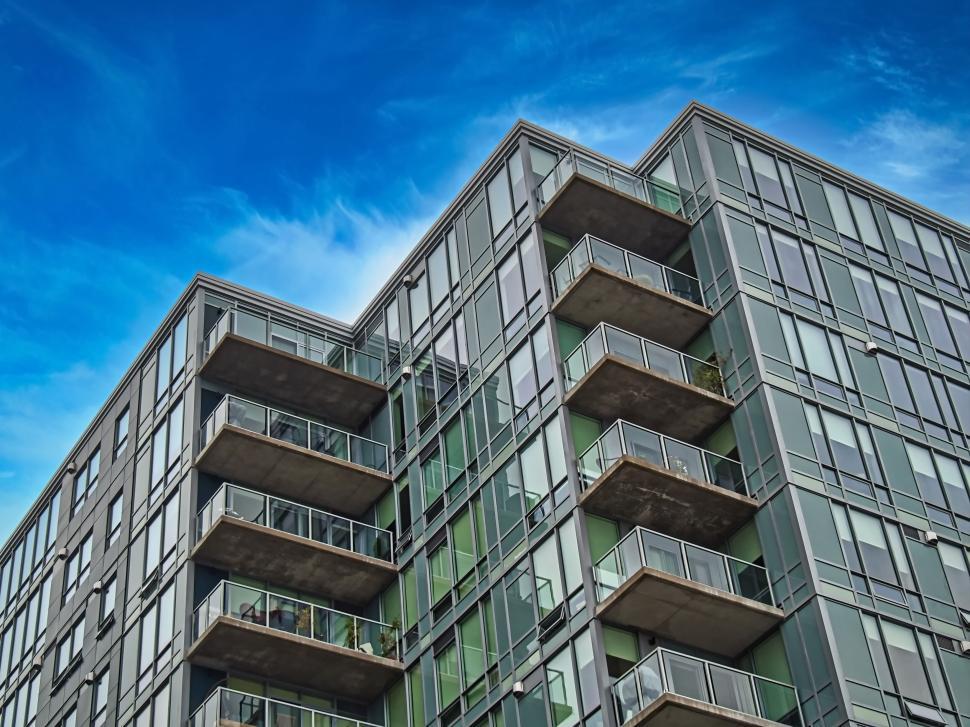 Free Image of Modern apartment building with glass balconies, daytime. 