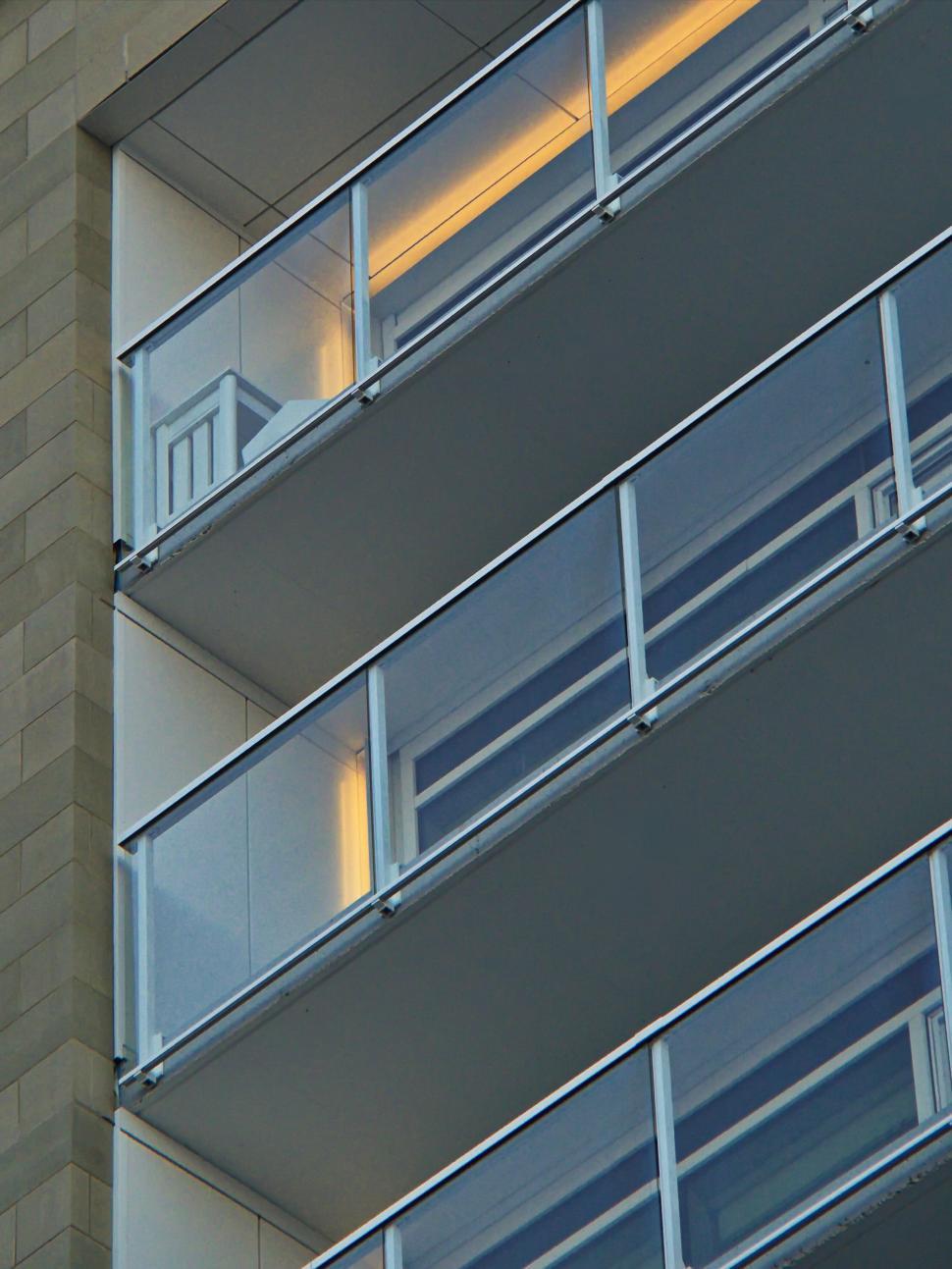 Free Image of Close-up of modern balcony with glass railings at night. 
