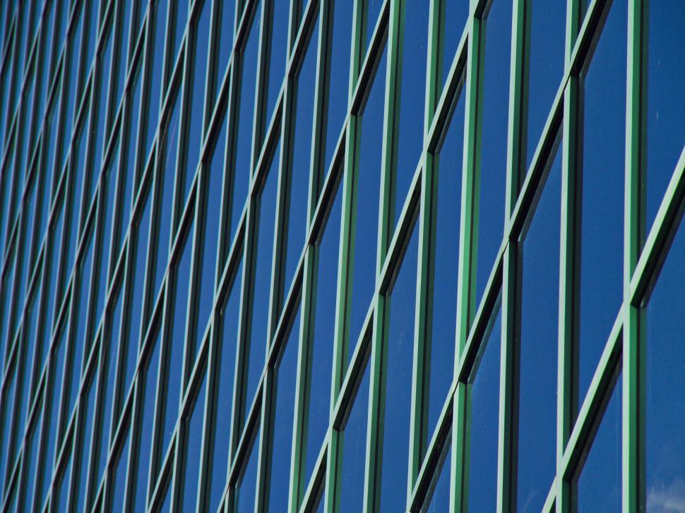 Free Image of Exterior of a modern building with green metal grid facade. 
