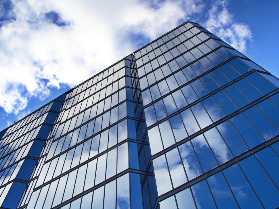 Free Image of Glass skyscraper with reflections of the clouds 