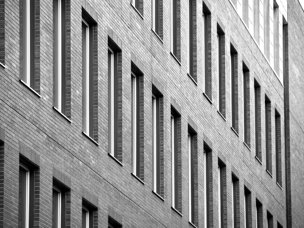 Free Image of Brick building facade with repeating window pattern 
