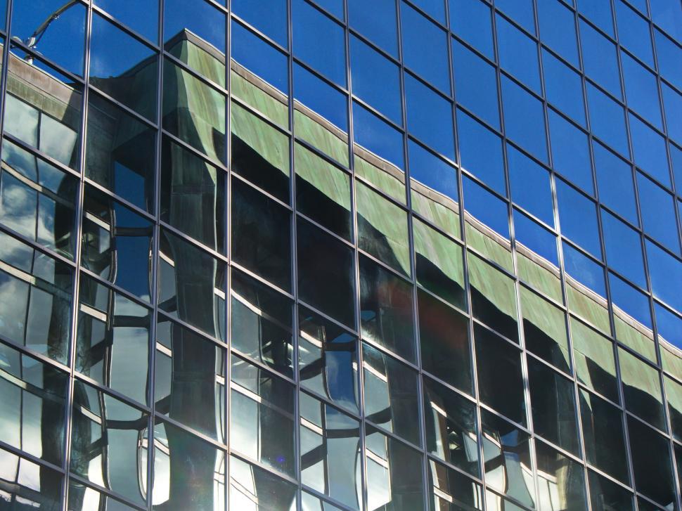 Free Image of Reflective glass windows of a modern building 