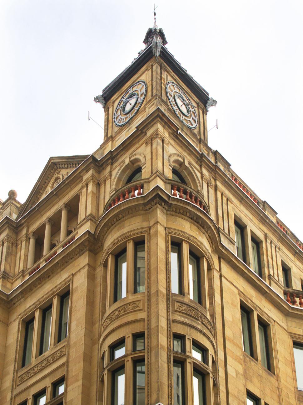 Free Image of Historical clock tower with classical arches 